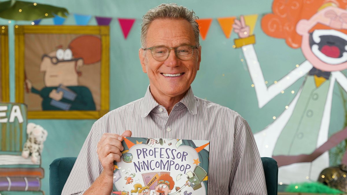 Bryan Cranston holding Professor Nincompoop on the Storyline Online set